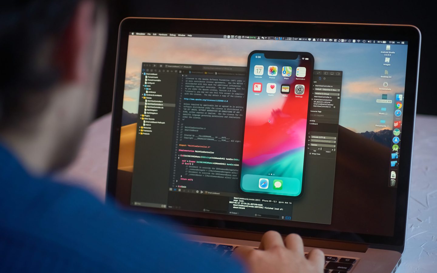 Bishkek, Kyrgyzstan - January 17, 2019: Man developer launches xcode software and ios simulator program to develop ios app on a MacBook